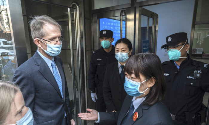 Australian Ambassador to China Graham Fletcher, left, is turned away by court officials and police as he tries to enter the trial of Chinese Australian journalist Cheng Lei at the Beijing Number 2 Intermediate People’s Court in Beijing, China, on March 31, 2022. (Kevin Frayer/Getty Images)