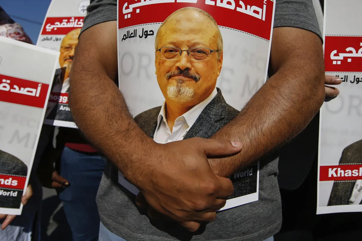 People hold posters of slain Saudi journalist Jamal Khashoggi, near the Saudi Arabia consulate in Istanbul, Turkey, on Oct. 2, 2020. (Emrah Gurel/AP Photo)