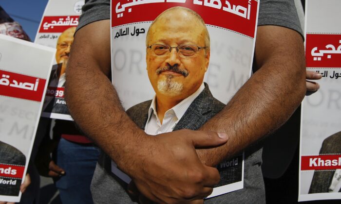People hold posters of slain Saudi journalist Jamal Khashoggi, near the Saudi Arabia consulate in Istanbul, Turkey, on Oct. 2, 2020. (Emrah Gurel/AP Photo)