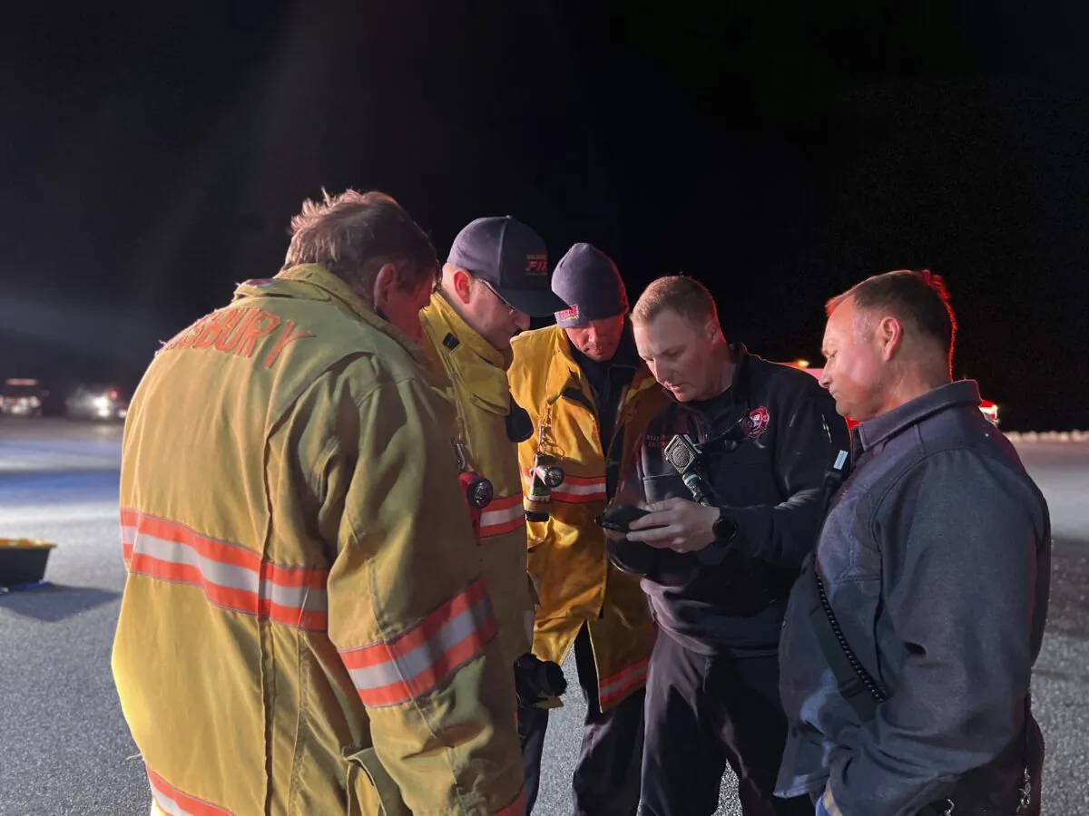 Emergency workers confer near Stockton, Md., on March 30, 2022, after a U.S. Navy E2-D Hawkeye aircraft crashed in waters near the Eastern Shore boundary of Virginia and Maryland. (Ryan Whittington/Ocean City Fire Department via AP)