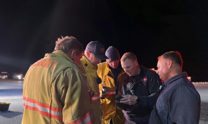 Emergency workers confer near Stockton, Md., on March 30, 2022, after a U.S. Navy E2-D Hawkeye aircraft crashed in waters near the Eastern Shore boundary of Virginia and Maryland. (Ryan Whittington/Ocean City Fire Department via AP)