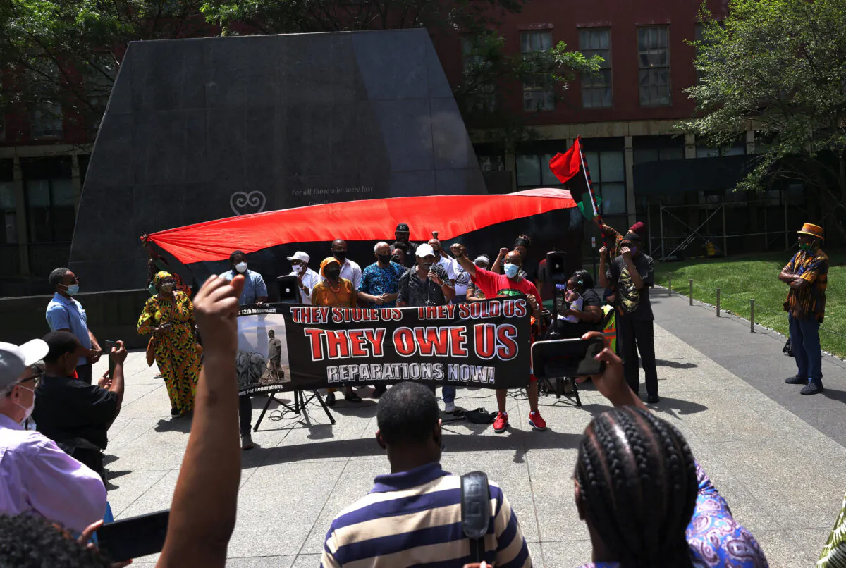 People listen to speakers during a rally for reparations at the African Burial Ground National Monument in New York on July 23, 2021. (Michael M. Santiago/Getty Images)