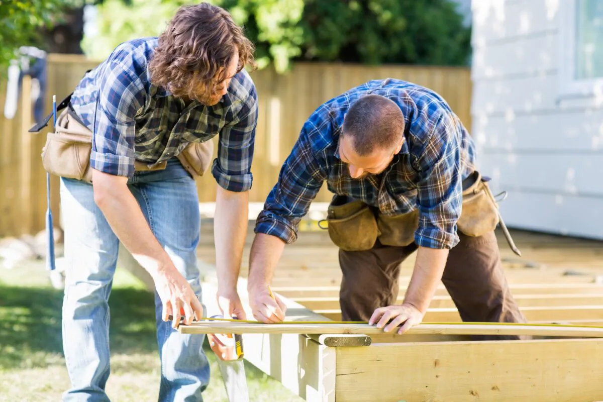 Fitting and attaching the decking boards is usually the easiest part of a deck building project. (Tyler Olson/Shutterstock)
