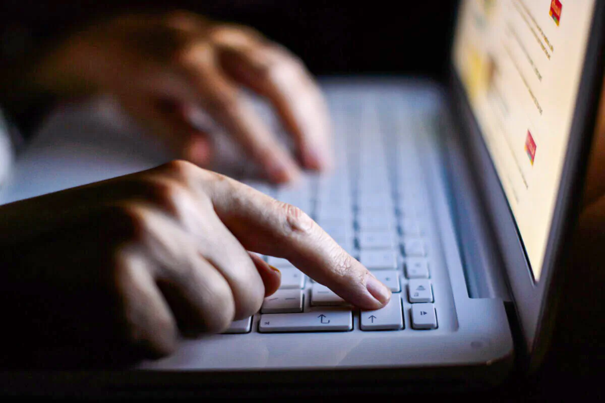 Hands on a keyboard, in an undated file photo. (PA)