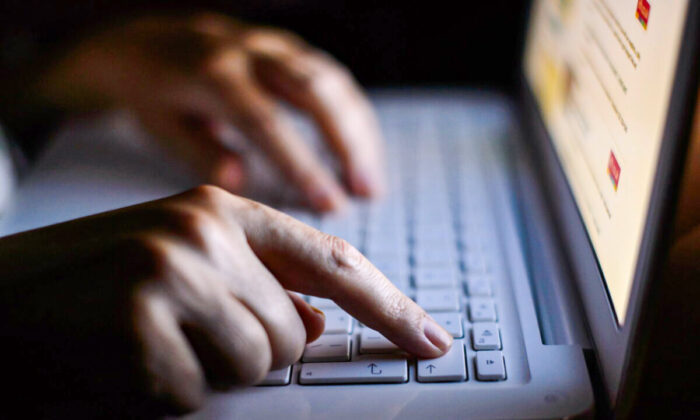 Hands on a keyboard in an undated file photo. (PA)