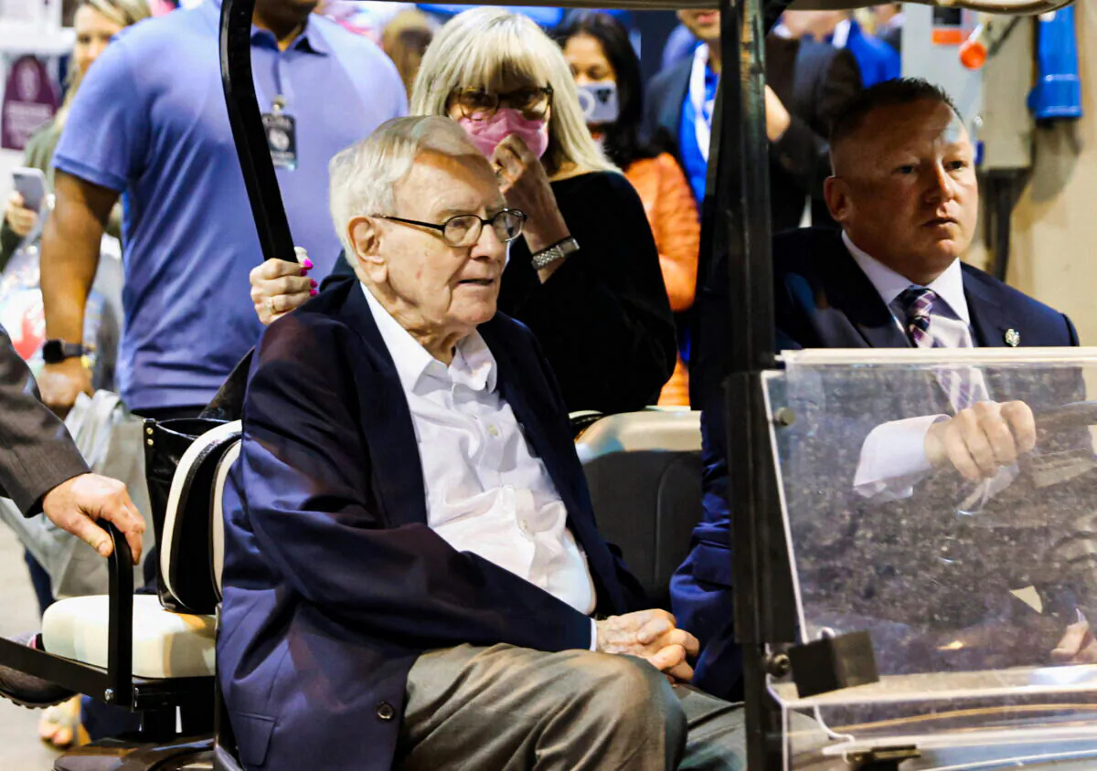 Berkshire Hathaway CEO Warren Buffett rides on a golf cart through the exhibition hall as investors and guests arrive for the first in-person annual meeting since 2019 of Berkshire Hathaway in Omaha, Neb., on April 29, 2022. (Scott Morgan/Reuters)