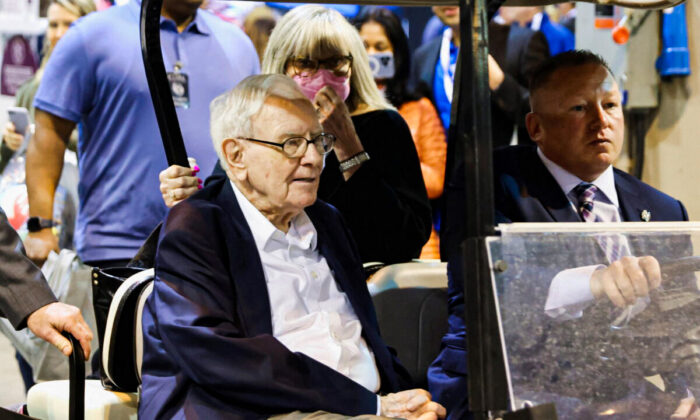 Berkshire Hathaway CEO Warren Buffett rides on a golf cart through the exhibition hall as investors and guests arrive for the first in-person annual meeting since 2019 of Berkshire Hathaway in Omaha, Neb., on April 29, 2022. (Scott Morgan/Reuters)