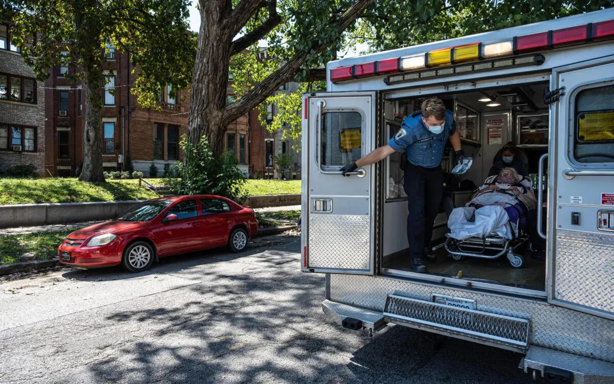 Louisville Metro EMS paramedics tend to a woman suspected of experiencing a severe COVID-19 emergency in an ambulance in Louisville, Ky., on Sept. 6, 2021. (Jon Cherry/Getty Images)