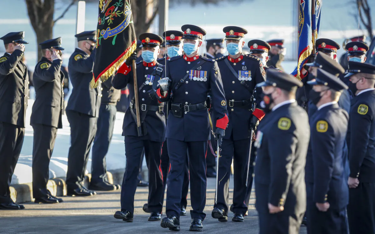 An honour guard marches at the funeral service for Calgary Police Service Sgt. Andrew Harnett in Calgary, Alberta, on Jan. 9, 2021. (Jeff McIntosh/The Canadian Press)