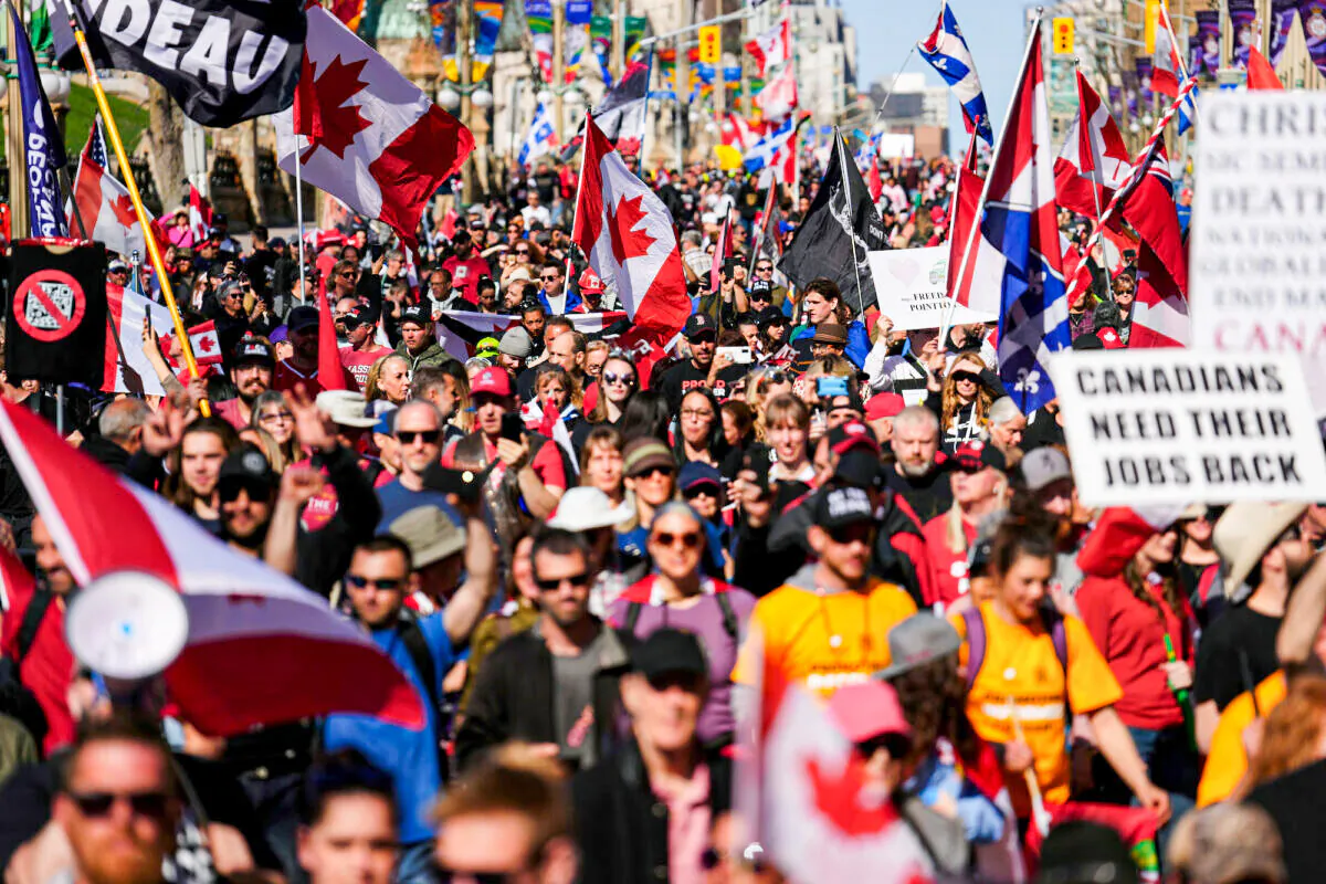 Protesters gather and wave flags during a demonstration in downtown Ottawa on April 30, 2022. (The Canadian Press/Sean Kilpatrick)