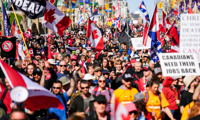 Protesters gather and wave flags during a demonstration in downtown Ottawa on April 30, 2022. (The Canadian Press/Sean Kilpatrick)