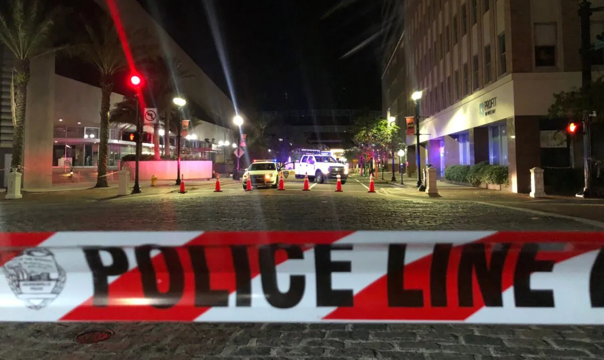Police cars behind police tape block a road in downtown Jacksonville in Fla., on Aug. 26, 2018. (Gianrigo Marletta/AFP via Getty Images)