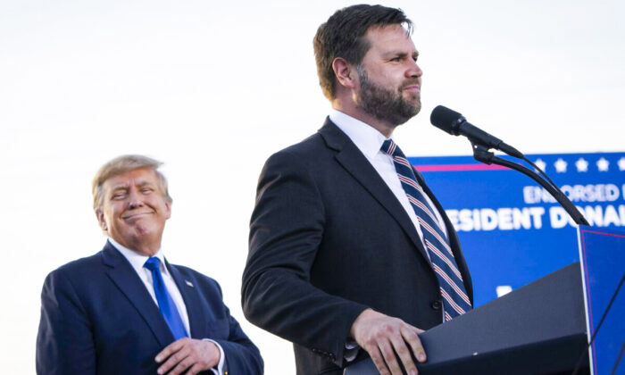 Former president Donald Trump (L) listens as J.D. Vance, a Republican candidate for U.S. Senate in Ohio, speaks during a rally hosted by the former president at the Delaware County Fairgrounds in Ohio on April 23, 2022. (Drew Angerer/Getty Images)