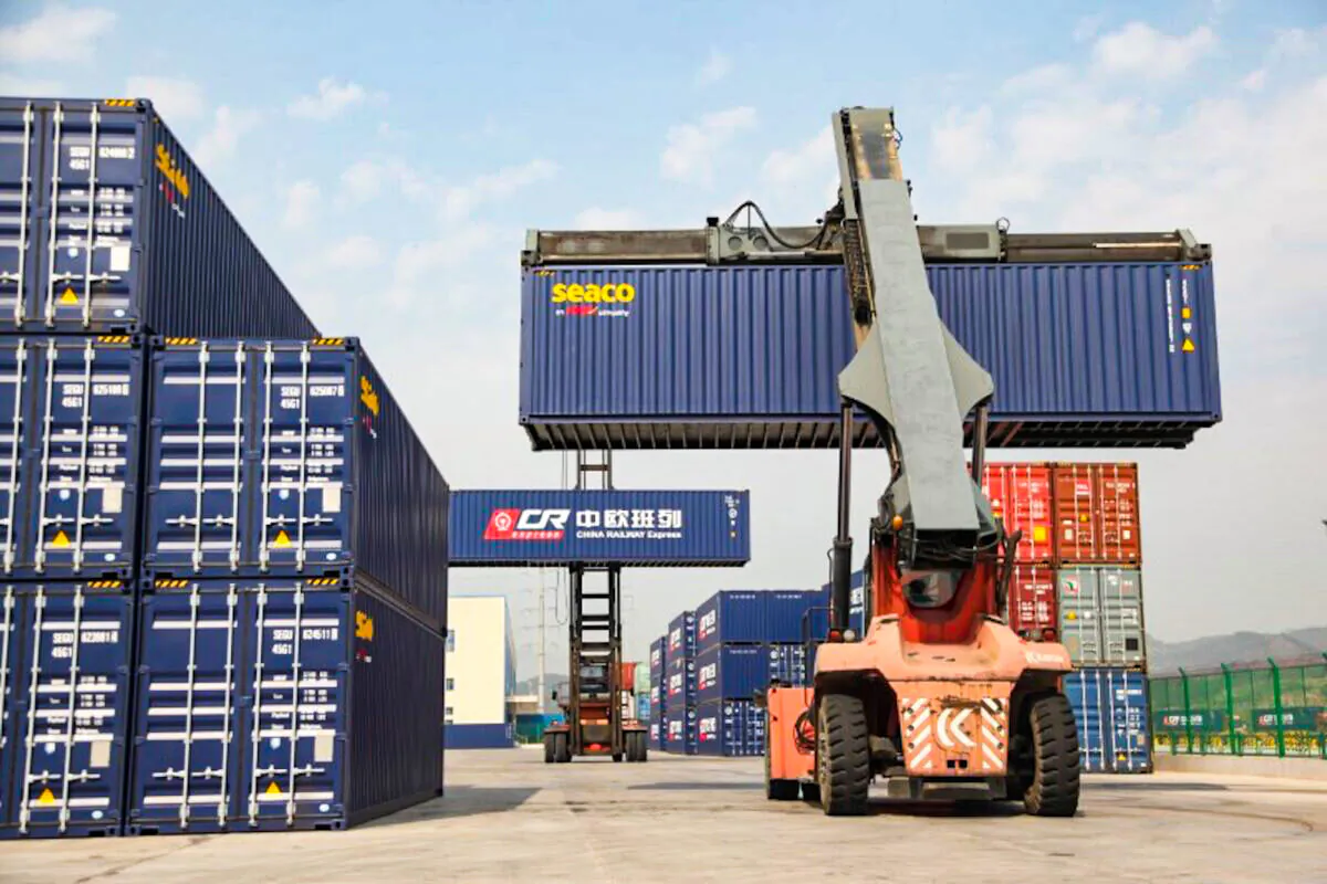 Container handlers transport containers at the railway port in Yiwu, Zhejiang Province, China on April 15, 2017. (Reuters)