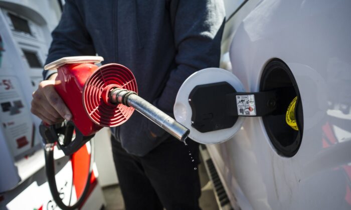 A man fills up his truck with gas in Toronto, on April 1, 2019. (The Canadian Press/Christopher Katsarov)