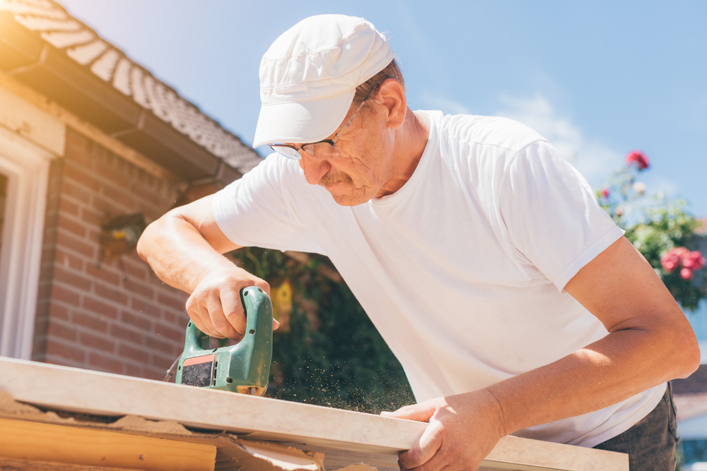 Carpenter,Old,Man,Using,Drill,Making,Holes,In,A,Wooden