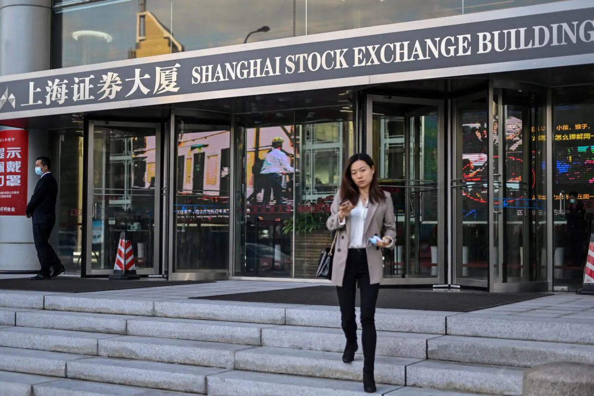 People walk outside the Shanghai Stock Exchange building in Shanghai, China, on Nov. 4, 2020. (Hector Retamal/AFP via Getty Images)