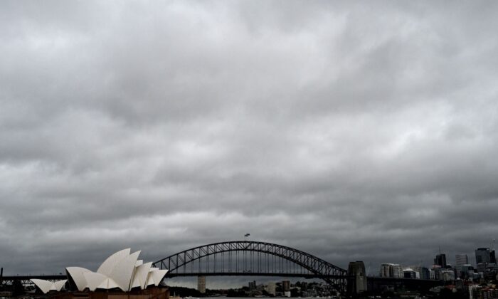 Storm clouds move over the Sydney Harbour Bridge and Opera House in Sydney, Australia, on March 8, 2022. (Muhammad Faroq/AFP via Getty Images)