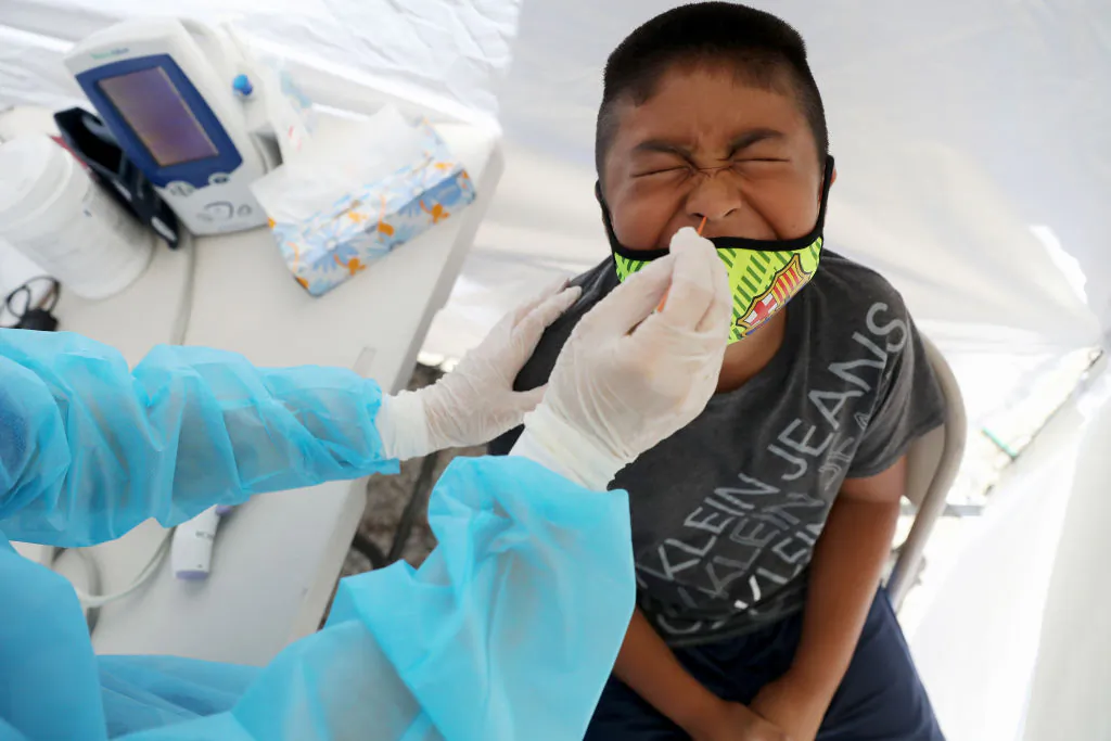 A boy receives a free COVID-19 test at a St. John’s Well Child & Family Center mobile clinic set up outside Walker Temple AME Church in South Los Angeles on July 15, 2020. (Mario Tama/Getty Images)