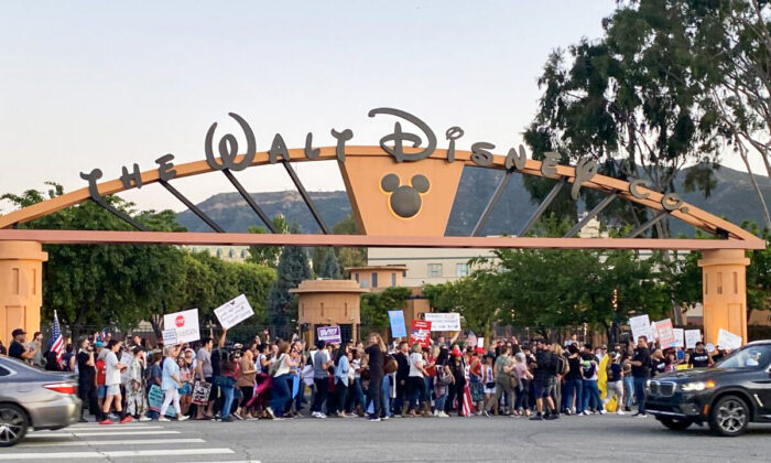 About 150 people attend a rally to oppose The Walt Disney Company's stance against a recently passed Florida law that prohibits schools from teaching their youngest students about sexual orientation and gender identity, outside of Disney's headquarters in Burbank, Calif., on April 6, 2022. (Jill McLaughlin/The Epoch Times)