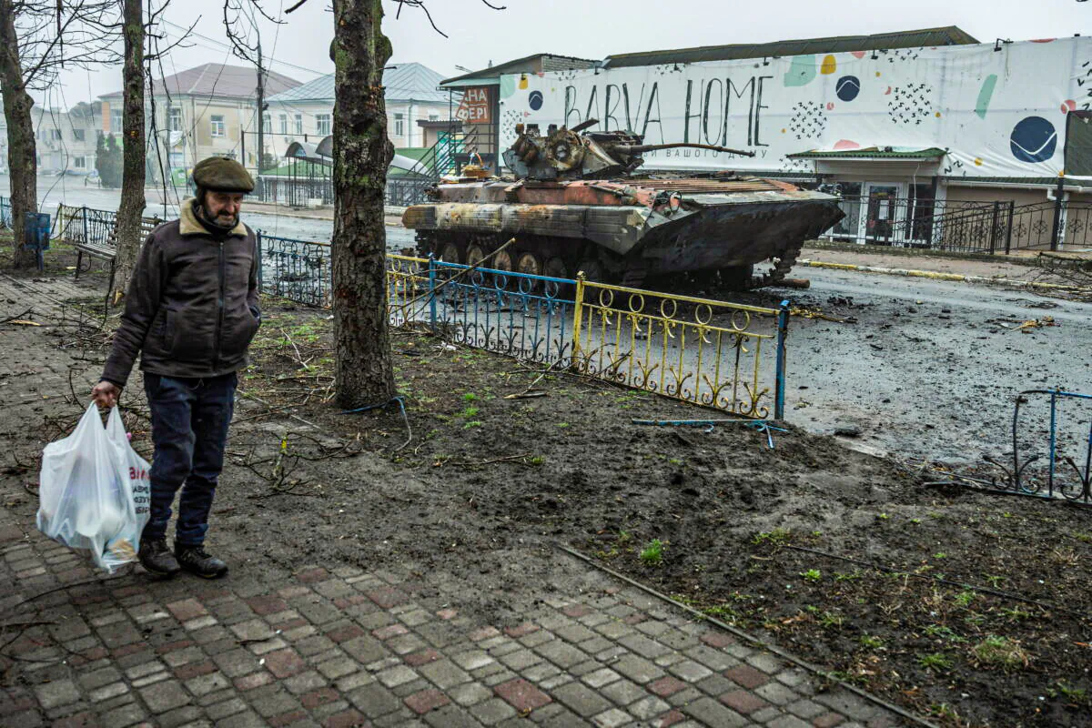A local man walks past a damaged armored personal carrier, as Russia's attack on Ukraine continues, in the town of Makariv, in Kyiv region, Ukraine, on April 1, 2022. (Serhii Mykhalchuk/Reuters)