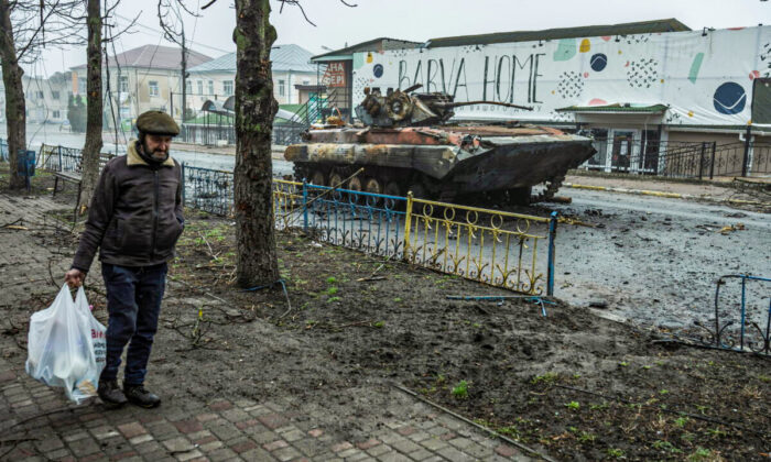 A local man walks past a damaged armored personal carrier, as Russia's attack on Ukraine continues, in the town of Makariv, in Kyiv region, Ukraine, on April 1, 2022. (Serhii Mykhalchuk/Reuters)