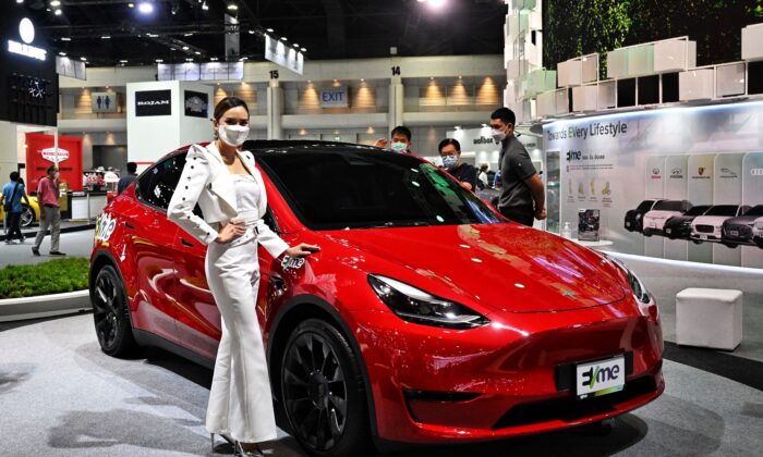 A model promotes the Tesla Model Y electric car at the Bangkok International Motor Show in Bangkok, Thailand on March 24, 2022. (Lillian Suwanrumpha/AFP via Getty Images)