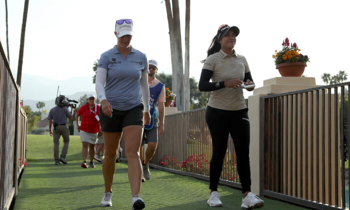 Patty Tavatanakit of Thailand and Jennifer Kupcho of the United States walk off the 18th hole following the third round of The Chevron Championship at The Westin Mission Hills Golf Resort & Spa on April 02, 2022 in Rancho Mirage, California. (Katelyn Mulcahy/Getty Images)