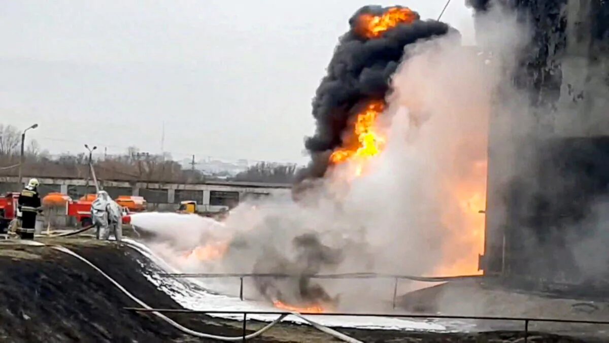 Members of the Russian Emergencies Ministry extinguish a fire at a fuel depot in the city of Belgorod, Russia, on April 1, 2022, in a still from video. (Russian Emergencies Ministry/Handout via Reuters)