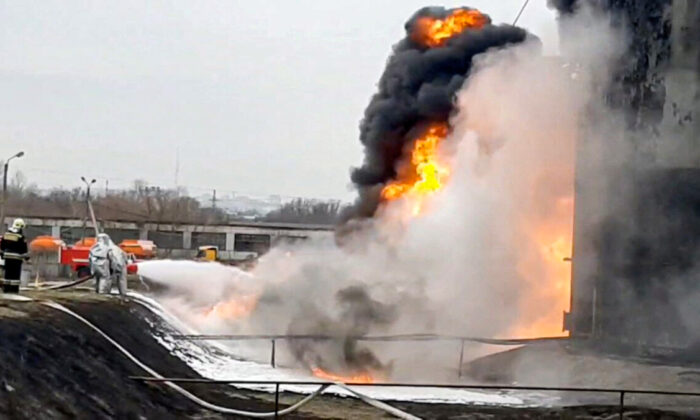 Members of the Russian Emergencies Ministry extinguish a fire at a fuel depot in the city of Belgorod, Russia, on April 1, 2022, in a still from video. (Russian Emergencies Ministry/Handout via Reuters)