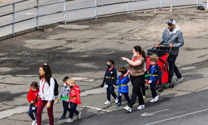 Children are seen walking, on the first day of lifting the indoor mask mandate for DOE schools between K through 12, in Manhattan, New York City, New York, on March 7, 2022. (Andrew Kelly/Reuters)