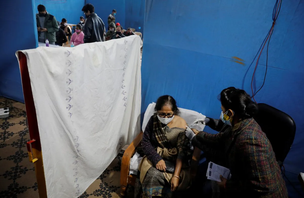 A woman receives a booster dose of Covaxin, a COVID-19 vaccine manufactured by Bharat Biotech, at a vaccination centre in New Delhi, India, on Jan. 10, 2022. (Adnan Abidi/Reuters)