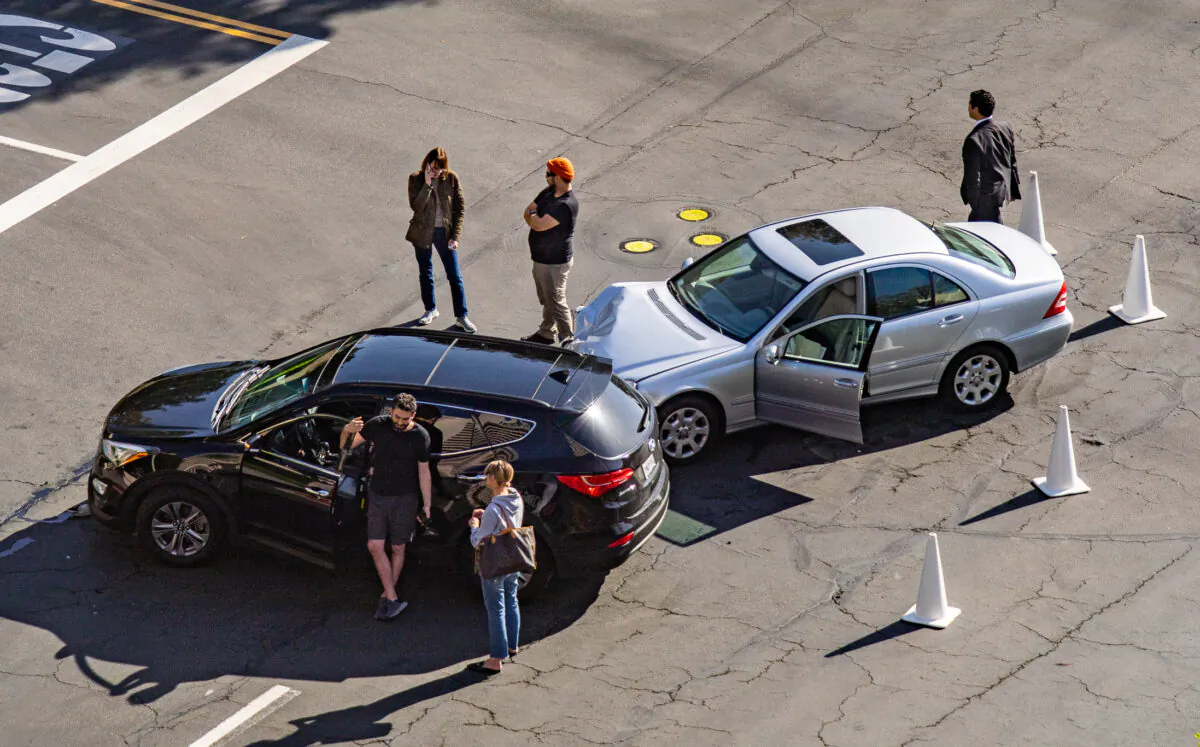 People handle the aftermath of a car accident in a file photo in Irvine, Calif., on March 30, 2022. (John Fredricks/The Epoch Times)