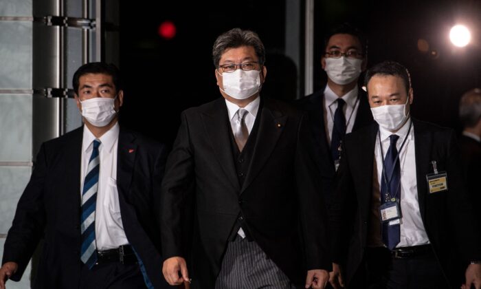 Japan's Economy, Trade and Industry Minister Koichi Hagiuda (C) arrives at the prime minister's office in Tokyo on October 4, 2021. (PHILIP FONG/AFP via Getty Images)
