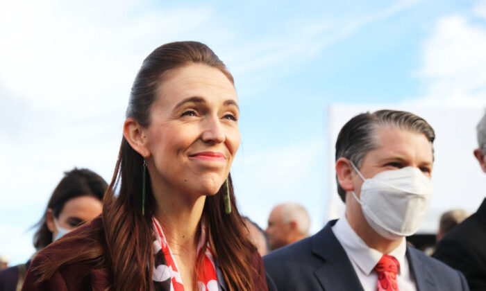 New Zealand Prime Minister Jacinda Ardern smiles after cutting the ribbon to open Transmission Gully SH1 motorway in Wellington, New Zealand, on March 30, 2022. (Lynn Grieveson/Getty Images)