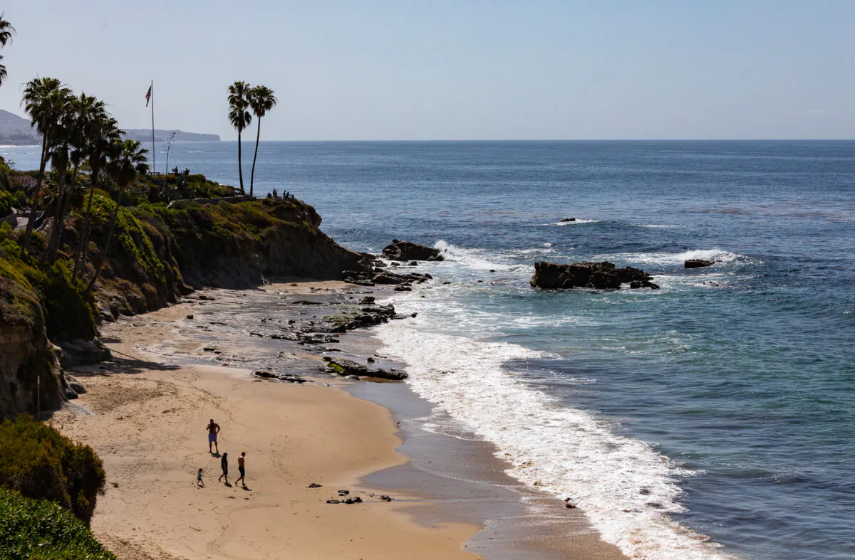 People enjoy the beach in Laguna Beach, Calif., on March 30, 2022. (John Fredricks/The Epoch Times)