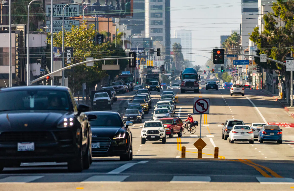 Cars and pedestrians travel in western Los Angeles, Calif., on Nov. 10, 2021. (John Fredricks/The Epoch Times)