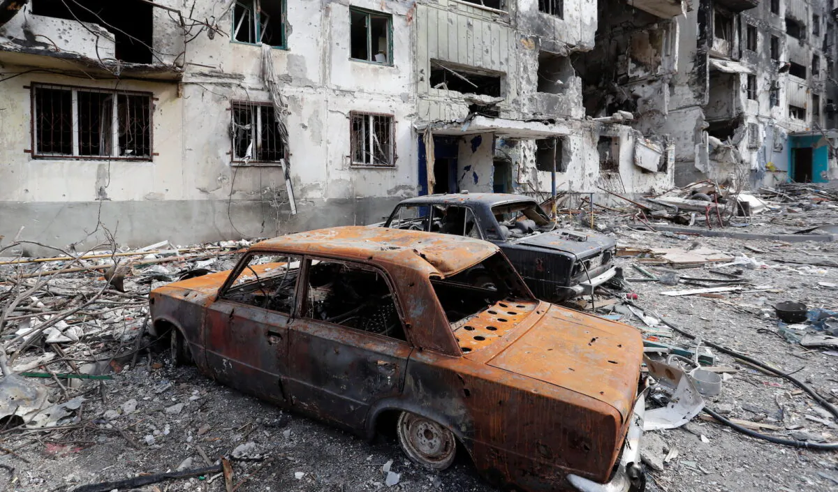 The remains of cars are seen in front of an apartment building destroyed during the Ukraine-Russia conflict in Mariupol, Ukraine, on April 3, 2022. (Alexander Ermochenko/Reuters)