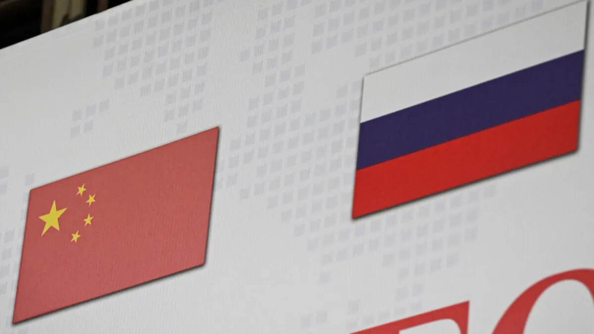 The Chinese and Russian national flags (R) on the international logistics billboard in Ritan International Trade Center in Beijing, on March 22, 2022. (Jade Gao/AFP via Getty Images)