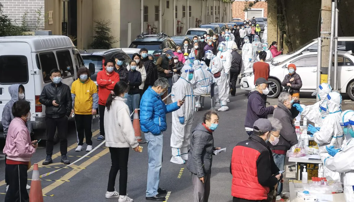 People line up for nucleic acid testing at a residential block during a citywide COVID-19 nucleic acid testing campaign in Shanghai, China on April 1, 2022. (Zhang Suoqing/VCG via Getty Images)