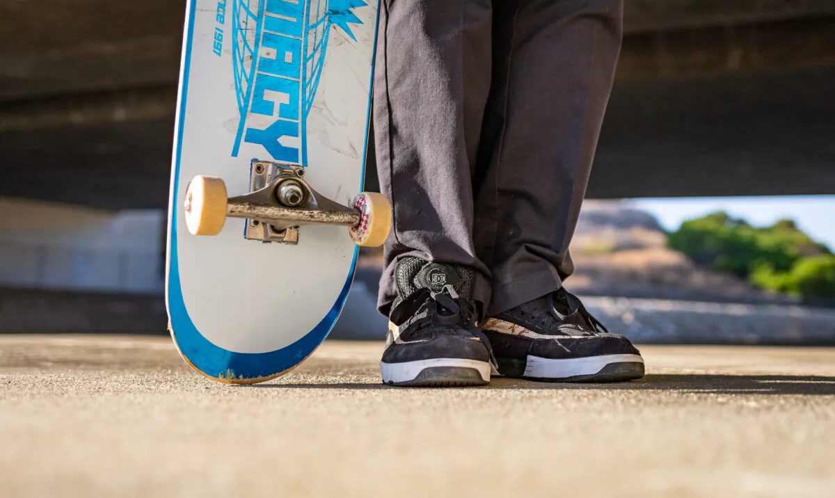 A skater holds his board in Laguna Niguel, Calif., on Sept. 30, 2020. (John Fredricks/The Epoch Times)