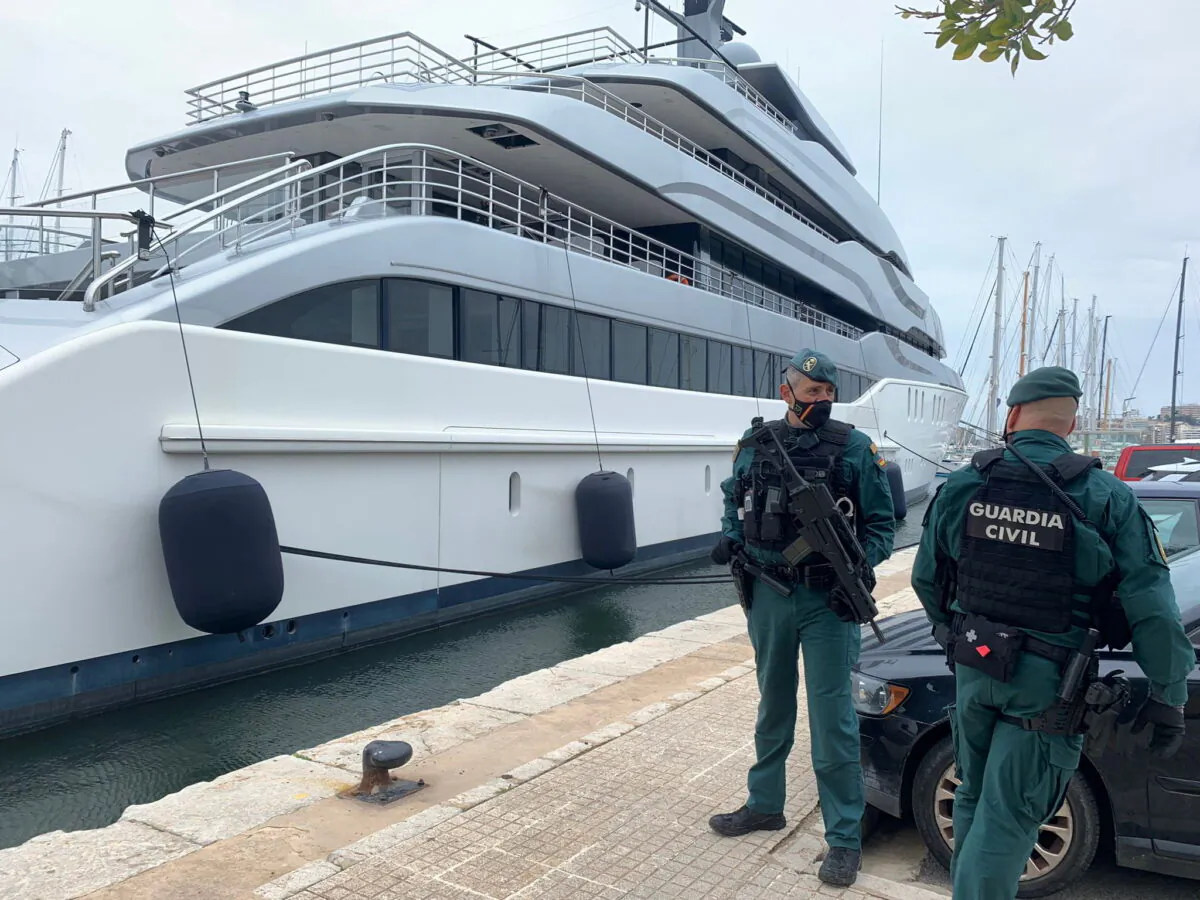 Spanish Civil Guards stand by the "Tango" superyacht, suspected to belong to a Russian oligarch, as it is docked at the Mallorca Royal Nautical Club, in Palma de Mallorca,  in the Spanish island of Mallorca, Spain, on April 4, 2022. (Juan Poyates Oliver/Handout via Reuters)