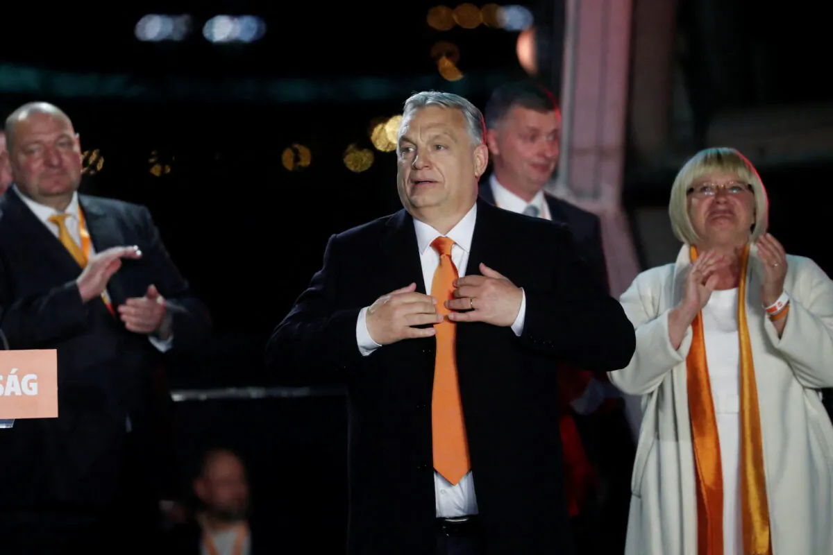 Hungarian Prime Minister Viktor Orbán reacts in front of supporters after the announcement of the partial results of parliamentary election in Budapest, Hungary, on April 3, 2022. (Bernadett Szabo/Reuters)