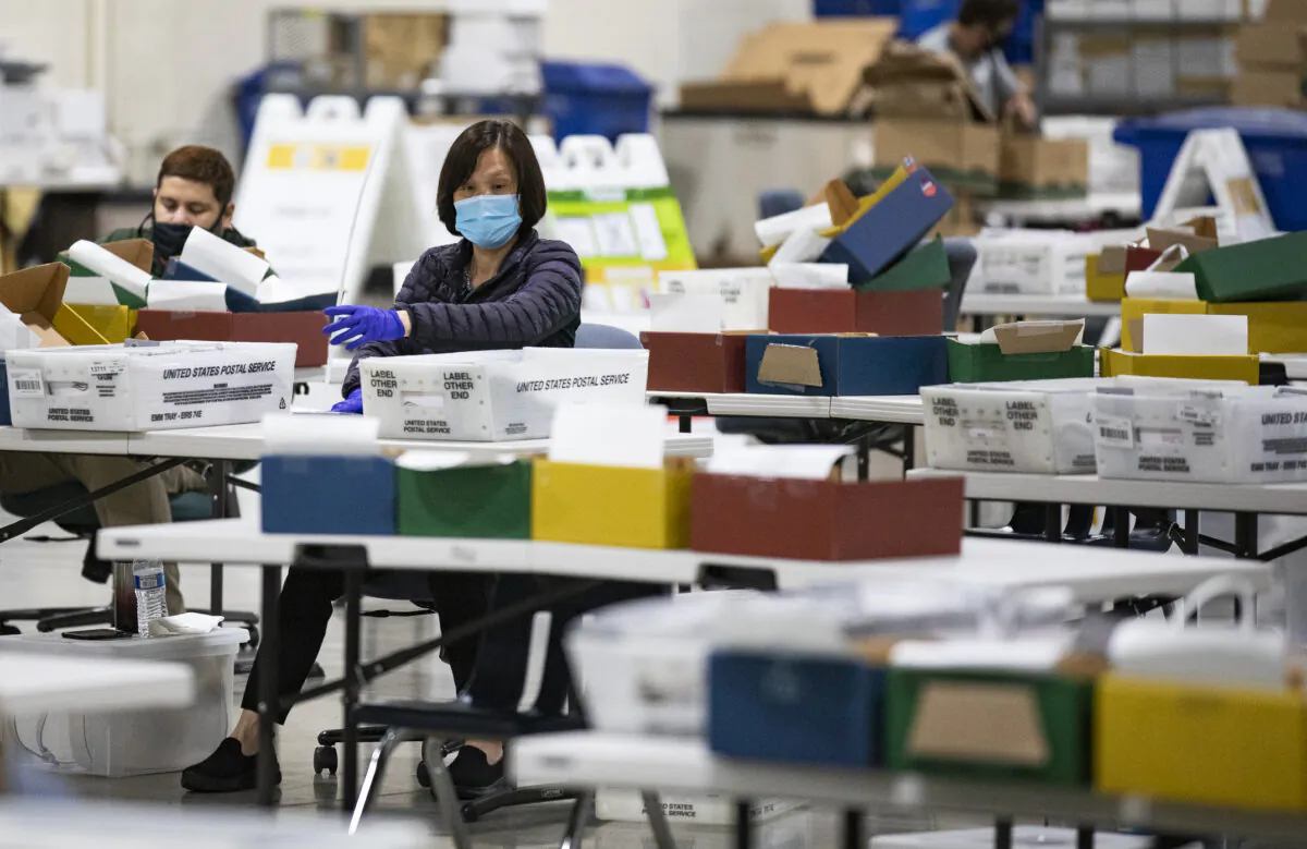 Los Angeles Registrars Office personnel process mail in voting ballots in Pomona, Calif., on Aug. 31, 2021. (John Fredricks/The Epoch Times)