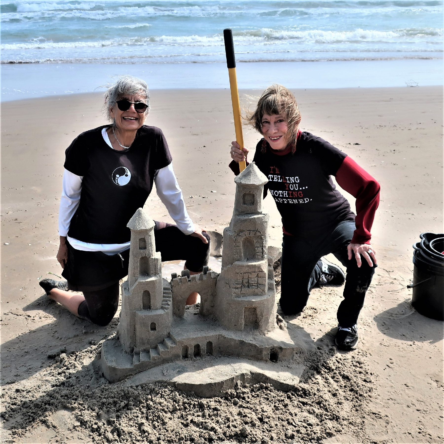 Lucinda Wierenga (left) gives the author a lesson in how to build a sandcastle on South Padre Island, Texas.