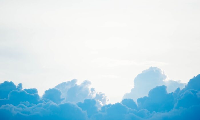 Stock photo of blue clouds in white sky. (Chuttersnap/Unsplash)