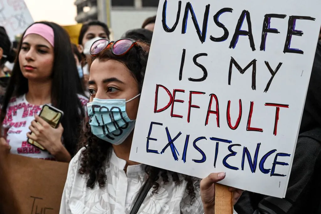 Human right activists hold placards as they march during a protest against an alleged gang rape of a woman, in Lahore, Pakistan, on Sept. 12, 2020. (Arif Ali/AFP via Getty Images)