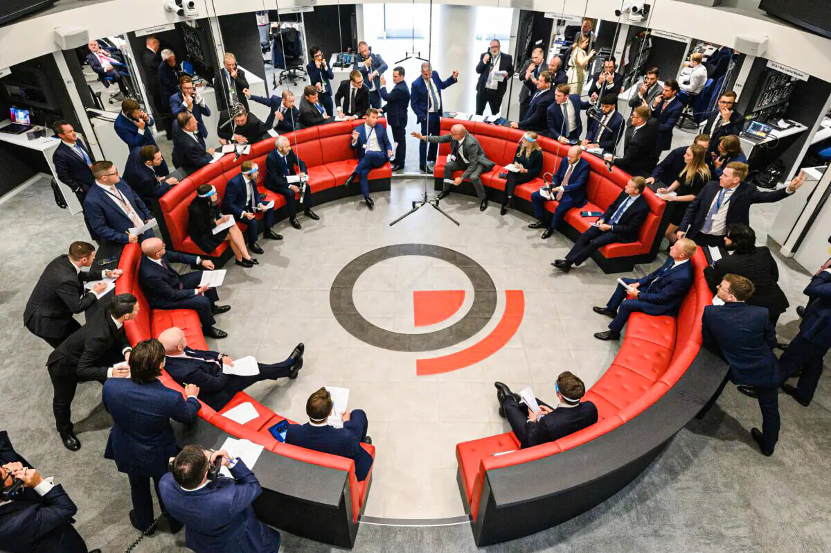 Traders, brokers and clerks shout and gesture on the first day of in-person trading at the London Metal Exchange in London on Sept. 6, 2021. (Leon Neal/Getty Images)