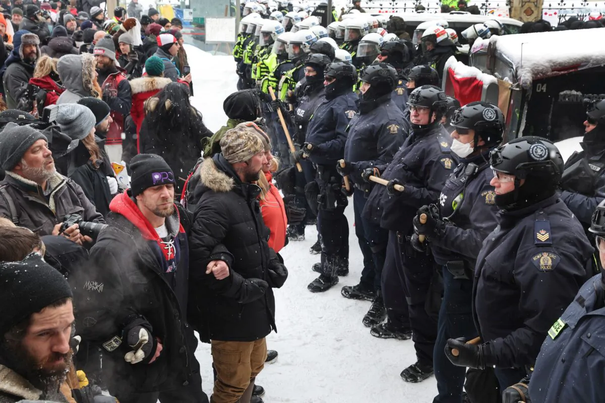 Police confront participants of the Freedom Convoy protest after the Emergencies Act was invoked, on Feb. 19, 2022. (Scott Olson/Getty Images)