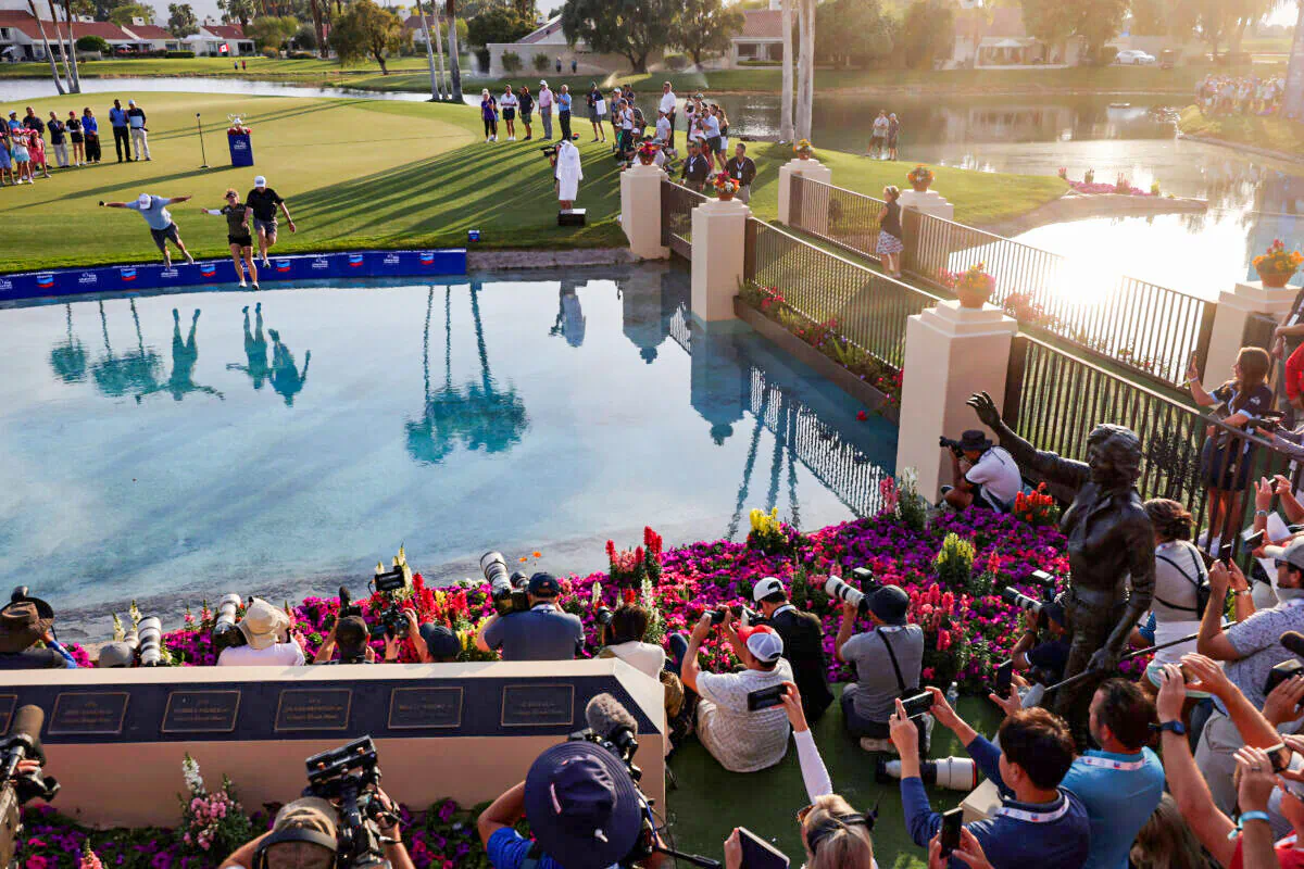 Jennifer Kupcho of the United States jumps into Poppie's Pond with husband, Jay Monahan (R), and her caddie (L), after winning The Chevron Championship at The Westin Mission Hills Golf Resort & Spa Rancho Mirage, Calif., on April 3, 2022. (Harry How/Getty Images)